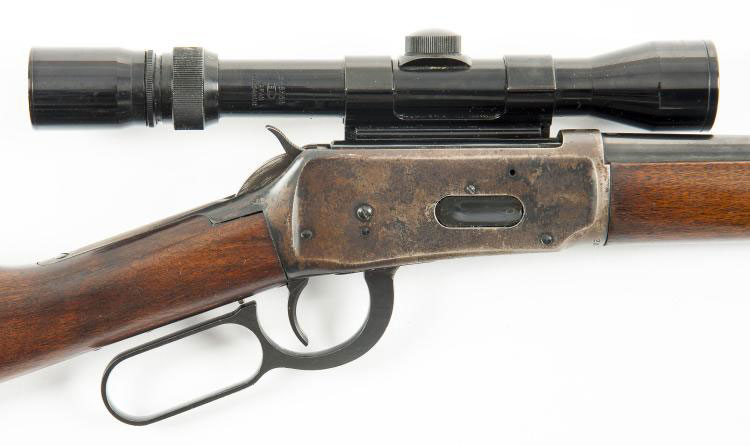 A side scope mounted on a Winchester 94 rifle