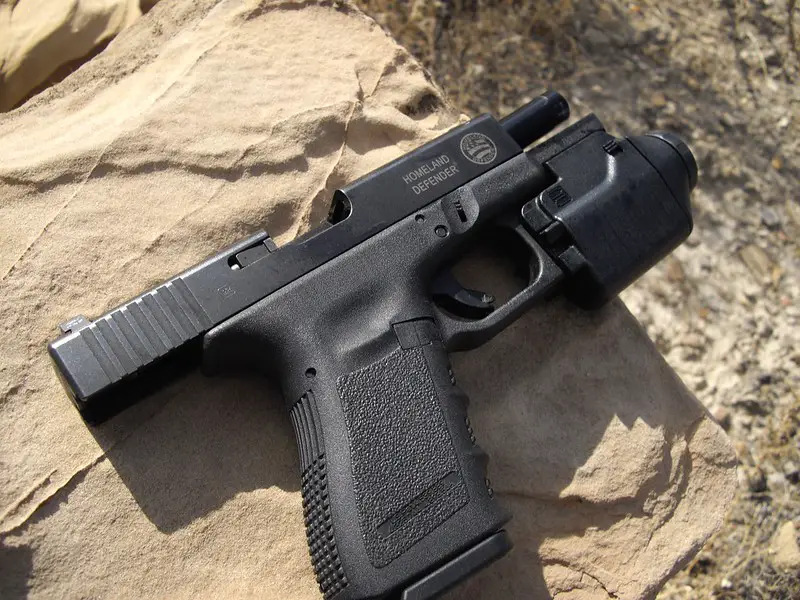 Glock 19 with flashlight mounted on it