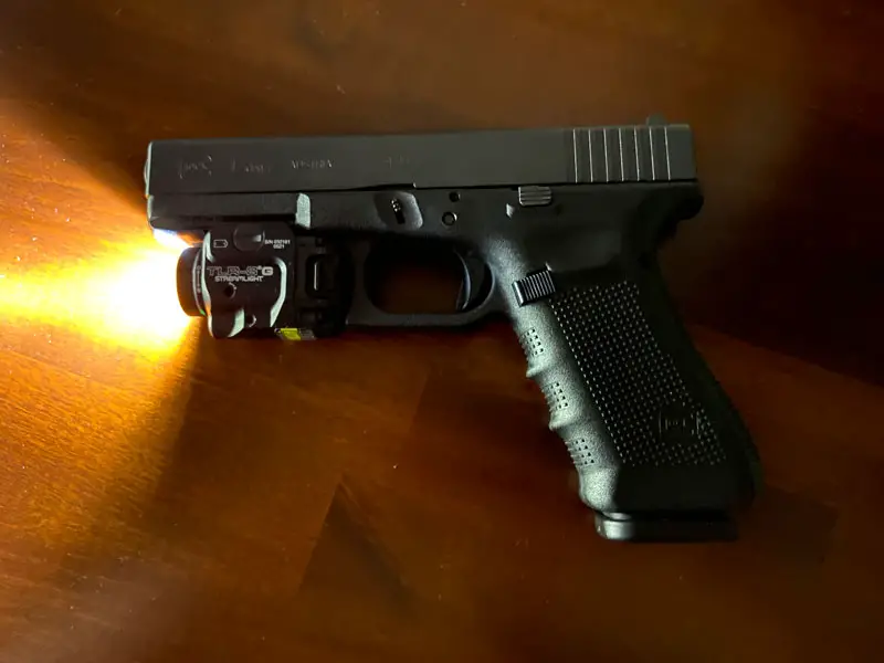Glock 17 9mm pistol with flashlight and laser mounted