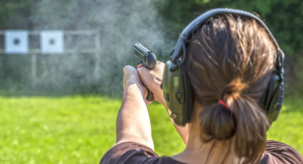 Woman shooting a pistol at a gun range