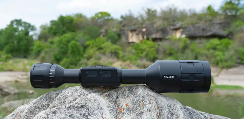 ATN Thor 4 Thermal Scope sitting on a rock