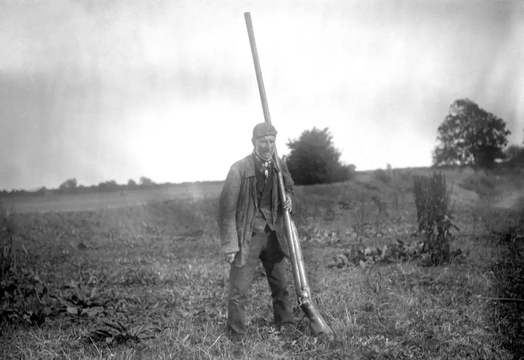 A man holding a massive punt gun