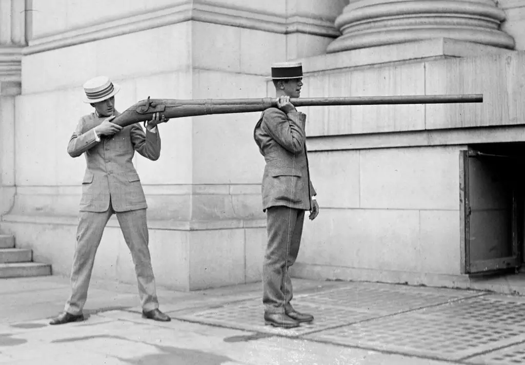 2 Men holding a massive punt gun shotgun