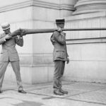 2 Men holding a massive punt gun shotgun