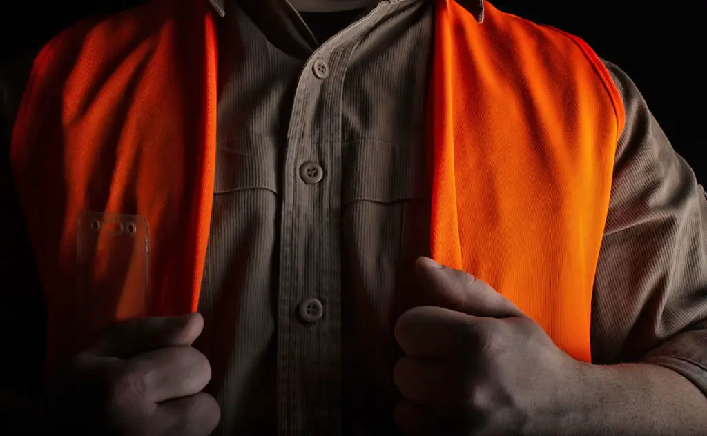 Man wearing a fluorescent orange vest for hunting