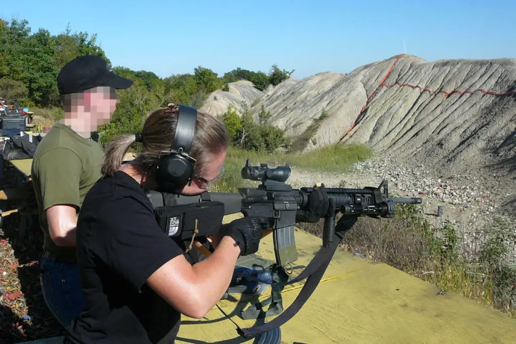 Woman shooting AR15 rifle at the range