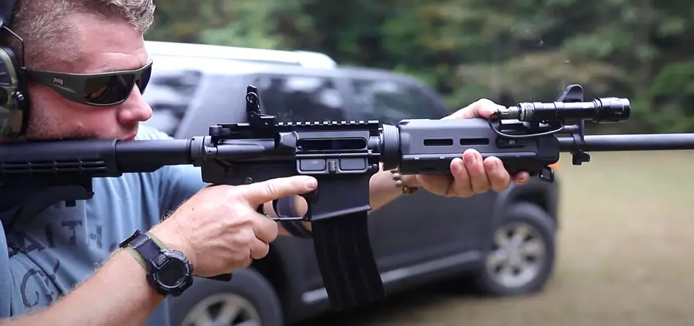 Man shooting an FN15 AR-15 rifle