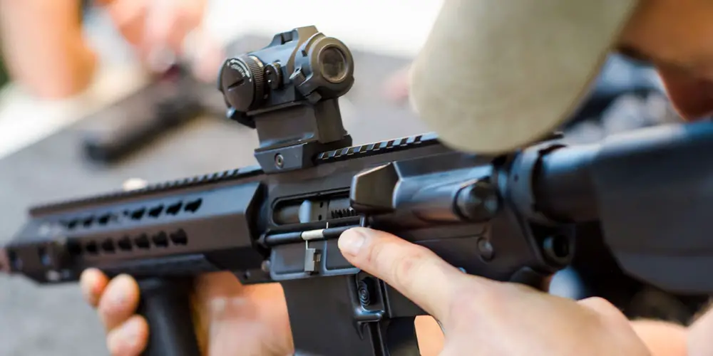 Assault rifle with red dot sight mounted on the rail
