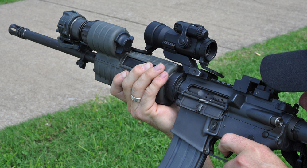 Assault rifle with scope and flashlight mounted on it