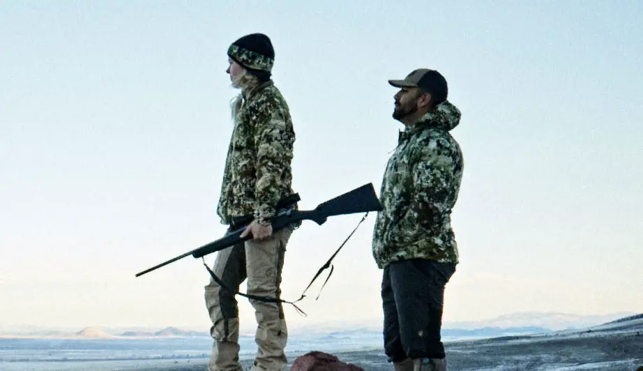 Two people hunting outside with the Mossberg Patriot rifle