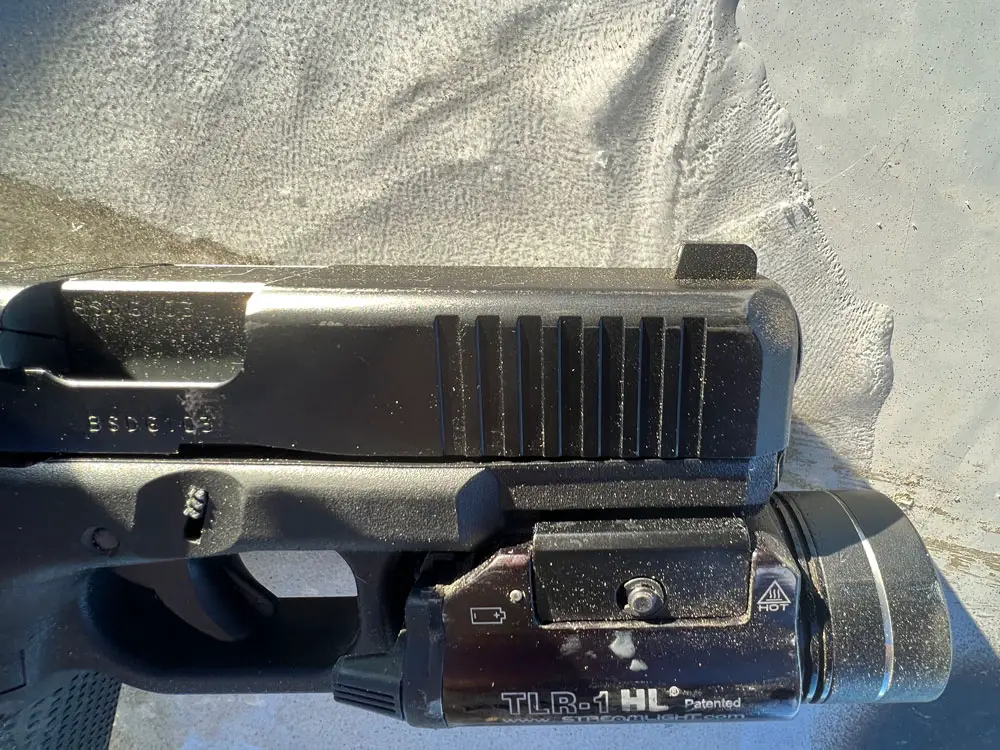 Glock 19 Gen 5 with a Streamlight TLR mounted on the rail