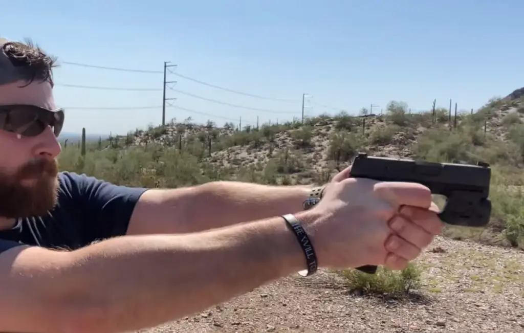 Side view of a man shooting the Sig P365 handgun