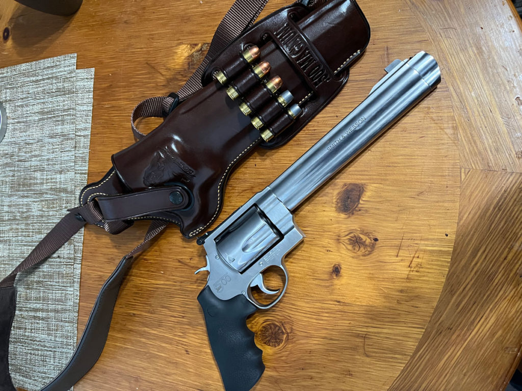 Smith & Wesson 500 next to the Galco Kodiak Chest Rig and Bandolier holding spare .500 Magnum rounds 