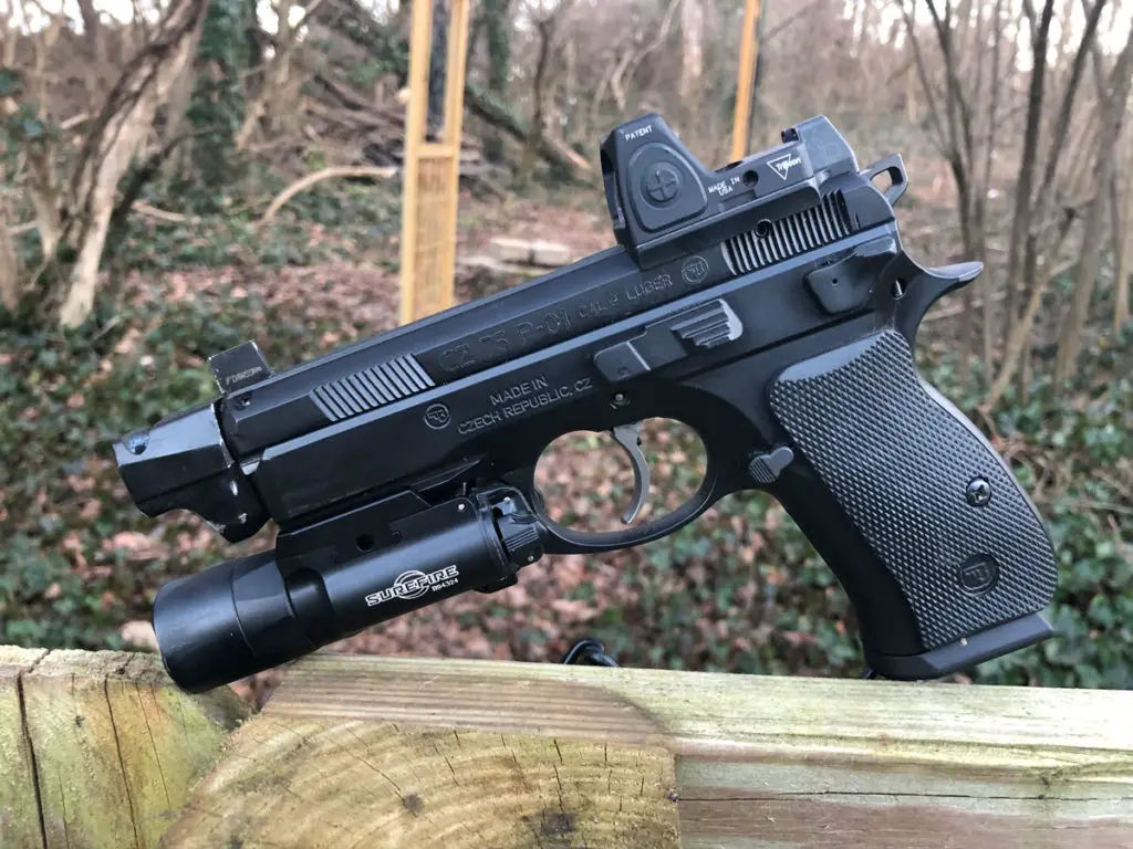 CZ 75 P01 Pistol side profile view of left sitting on a fence in the woods