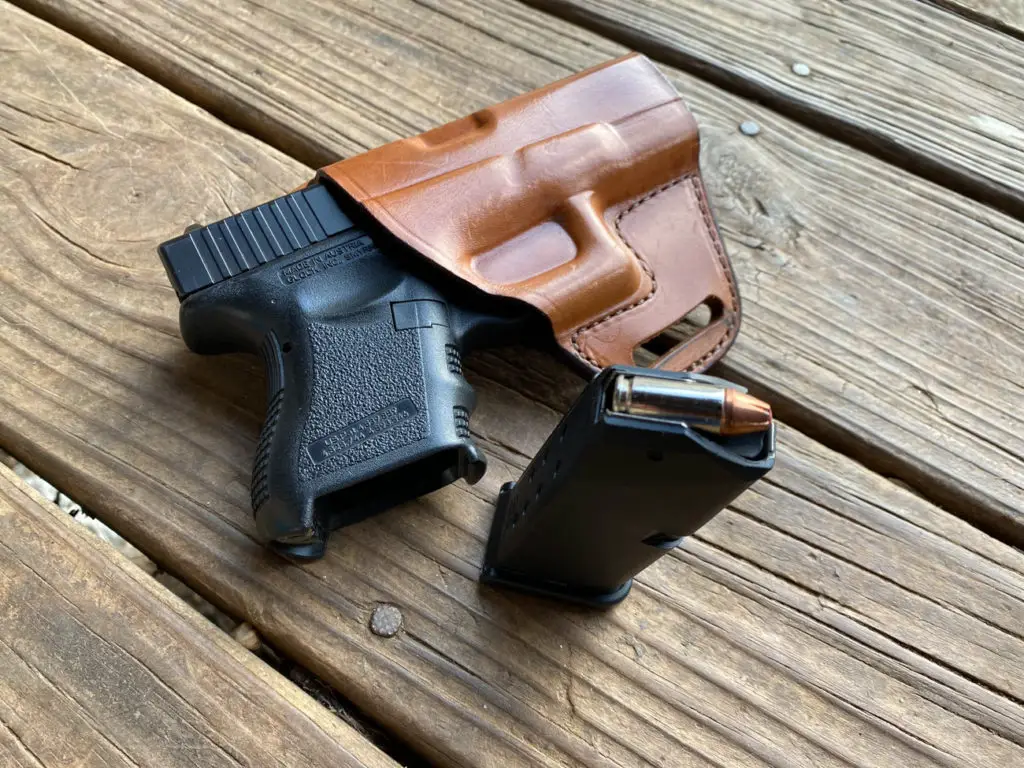 Glock 26 with leather holster and loaded magazine