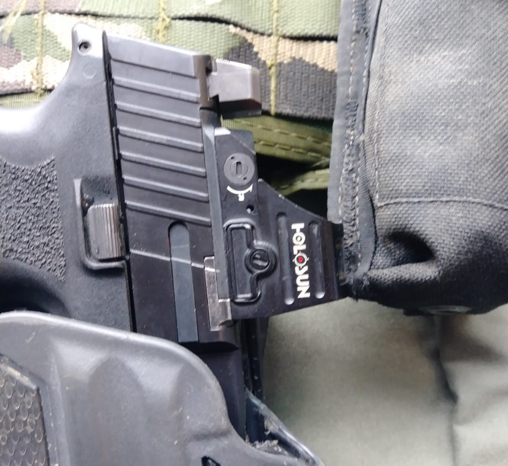 Holosun 507c mounted on a pistol in a holster