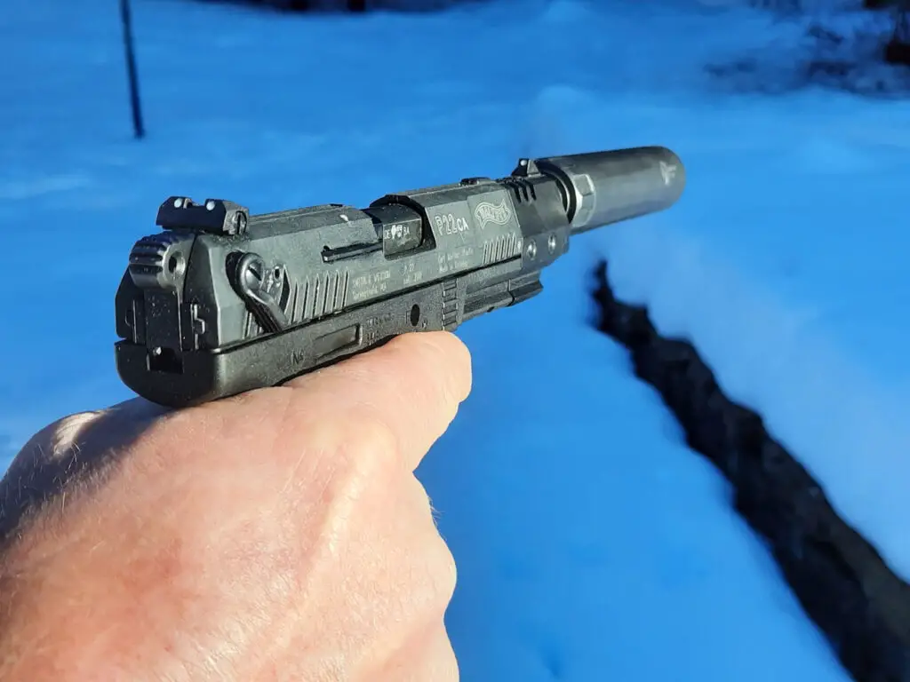 Walther P22 being held and shot with a supressor