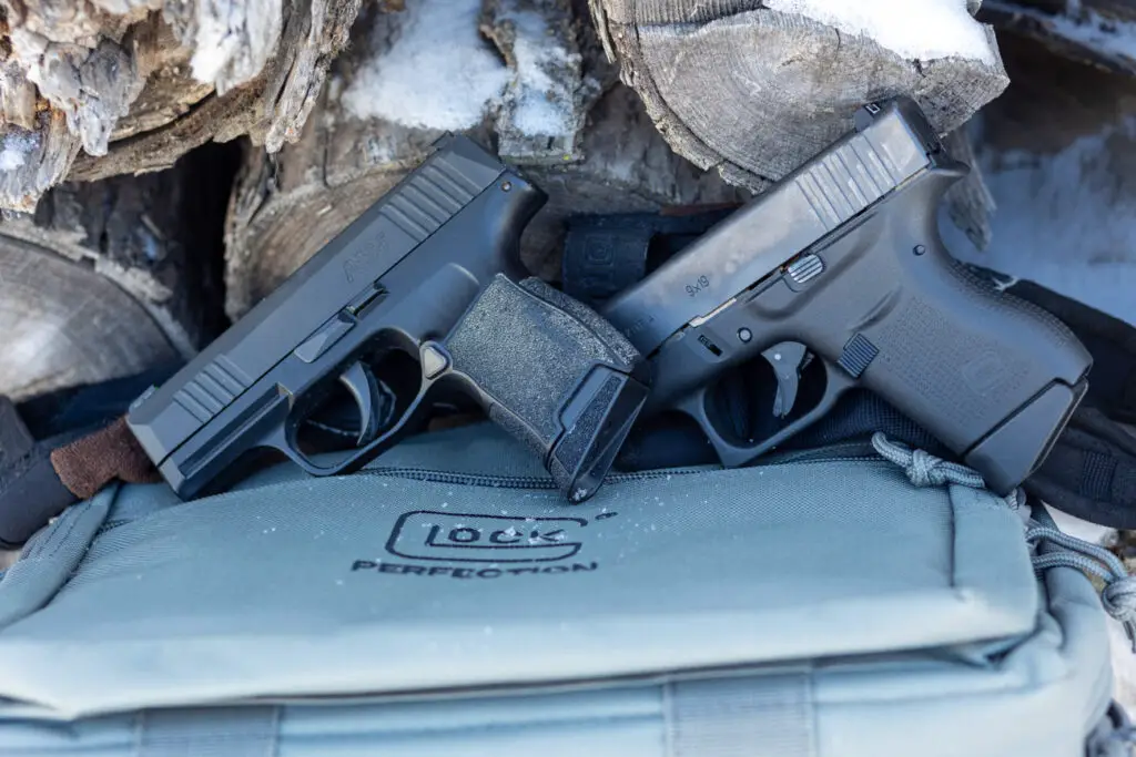 Glock 43 next to Sig P365 pistol