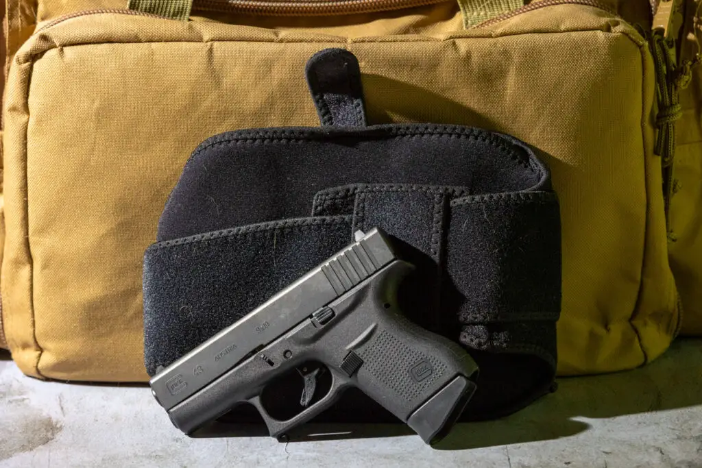 Glock 43 pistol sitting in front of range bag