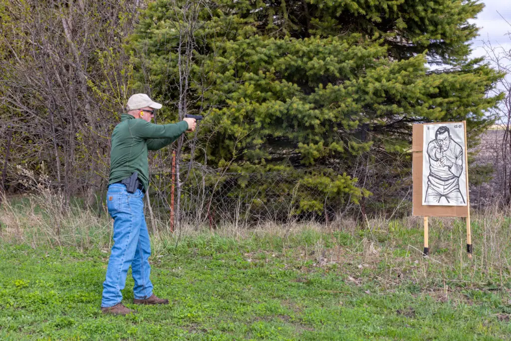 Man shooting a glock 19 pistol at a target