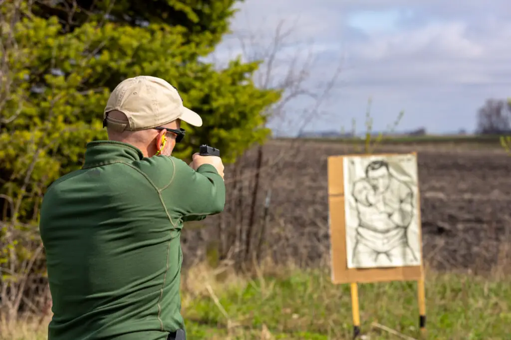 man shooting the G19 pistol at a target on the gun range