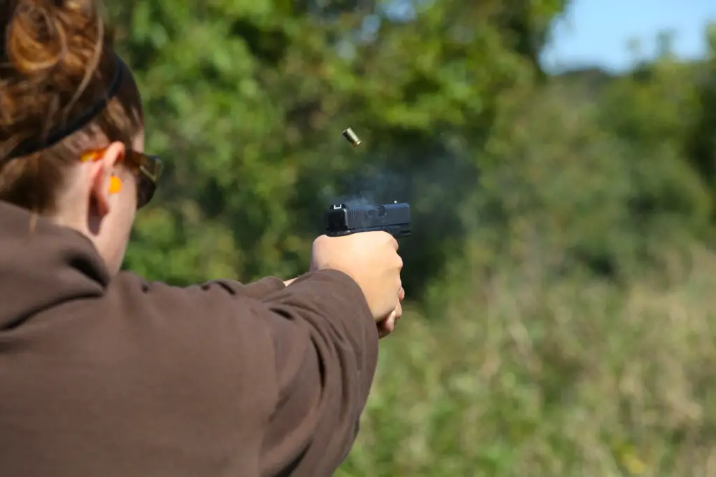 Glock 19 Pistol being fired and a casing being ejected from the side