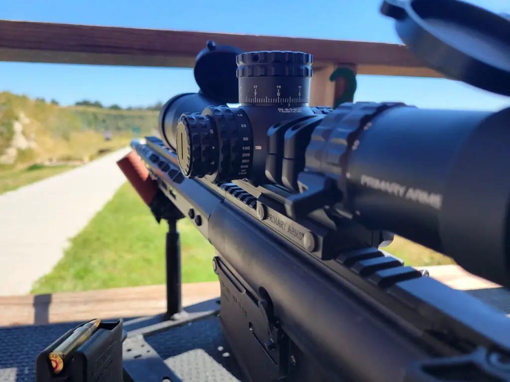 Primary Arms SLx 3-18x50 looking down range mounted on a rifle