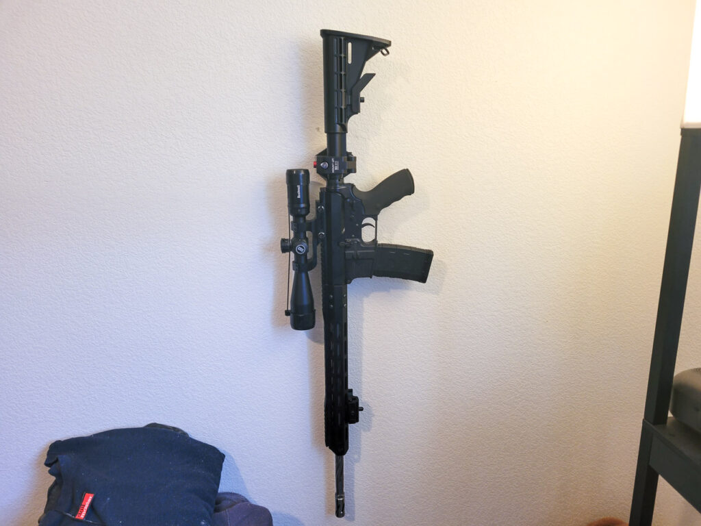 IC13 Mount Up! with an AR15 mounted in it on the wall