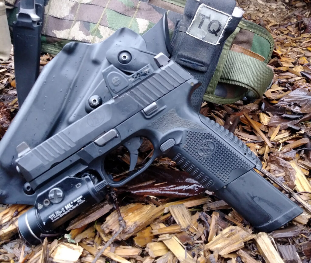 FN 509 with extended magazine, flashlight, and red dot sight