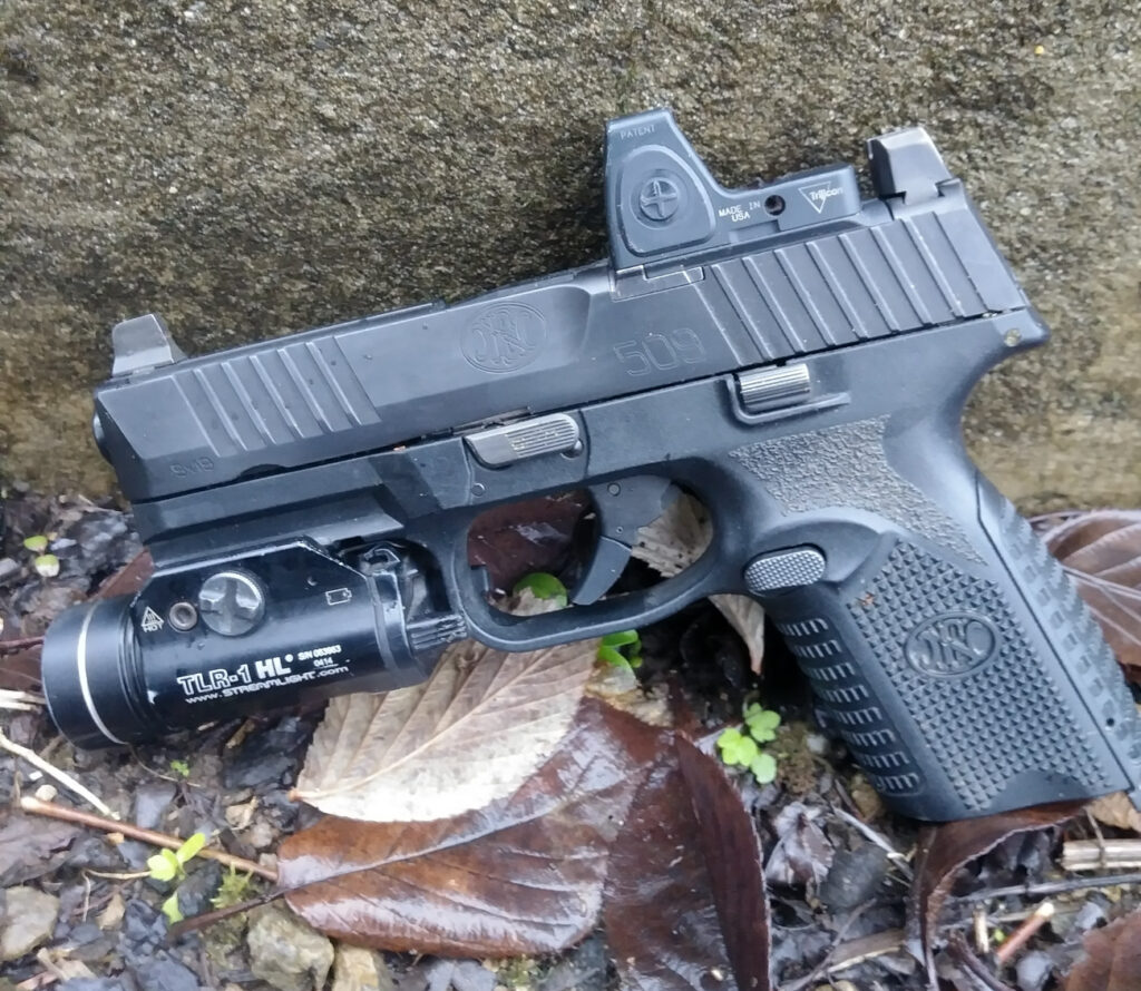 FN 509 with flashlight and red dot sight sideview of pistol