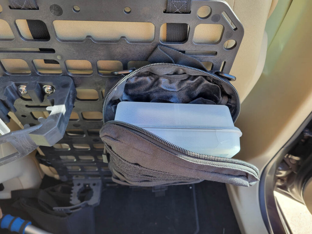 Medical Kit stored in a pouch on the Grey Man Tactical Vehicle Seat Rifle Rack